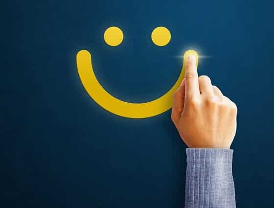 Hand of client show a feedback with smiley face. Service rating, satisfaction concept
